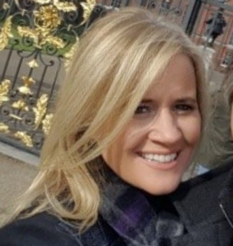 A photo of a smiling blonde woman.